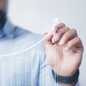 man giving a bar graph presentation using a high technology digi